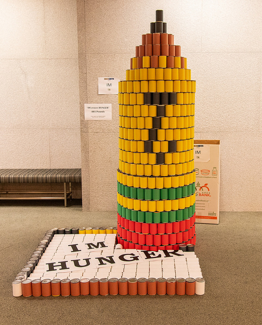 photo of cans stacked in the shape of a pencil