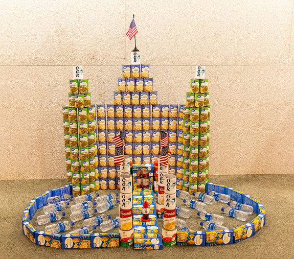 photo of cans stacked in the shape of a castle